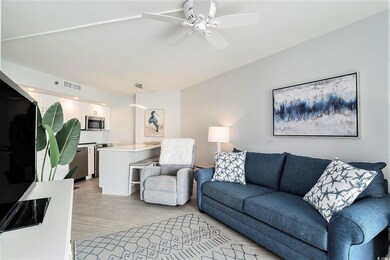 Living room with light wood-style flooring and a ceiling fan