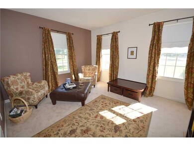 Living Room. Living room features neutral carpetin