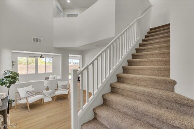 Stairway featuring wood finished floors, a towerin