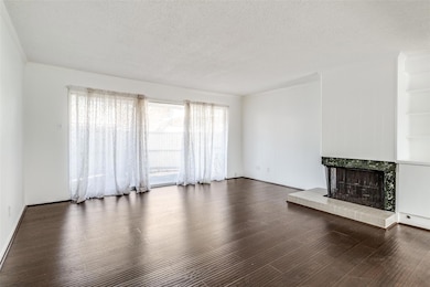 Unfurnished living room featuring a tile fireplace