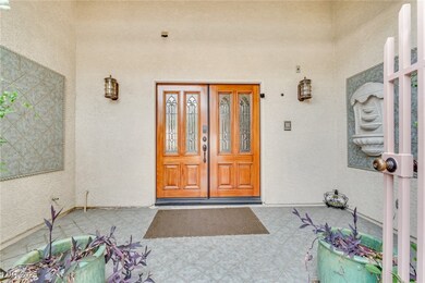 Entrance to property featuring stucco siding and a patio