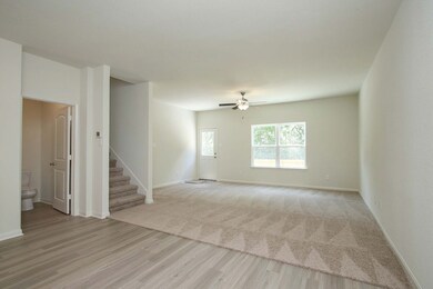 This open living room is great for entertaining and should fit your sectional, tv stand and coffee table.