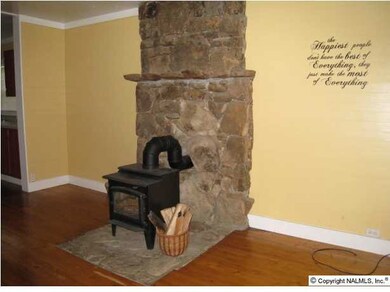 living room features wood burning stove/fireplace