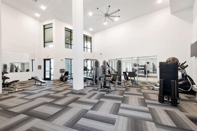 Gym featuring a healthy amount of sunlight, high v