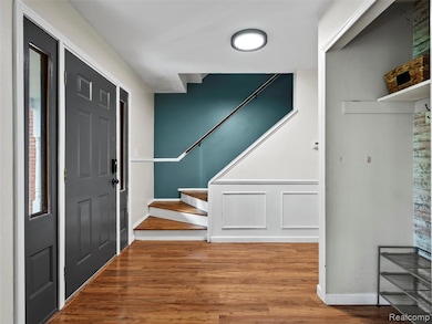 Foyer entrance featuring stairs and light wood-style flooring