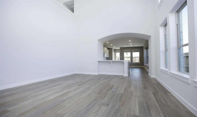 Unfurnished living room featuring wood finished f