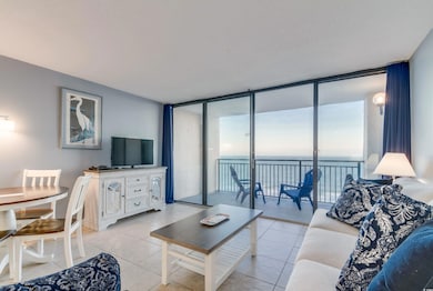 Living room with expansive windows and light tile 
