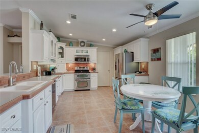 Kitchen featuring white cabinets, appliances with