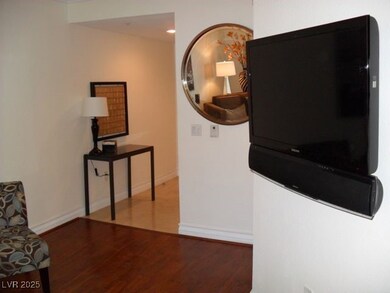 Hallway with baseboards and wood finished floors