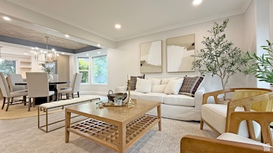 Living area with crown molding, light wood-type flooring, recessed lighting, and a chandelier