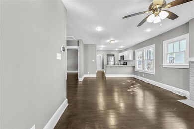 Unfurnished living room featuring dark wood-style 