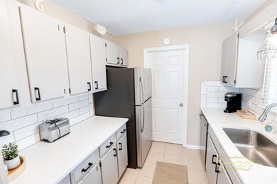 Kitchen featuring decorative backsplash, stainless