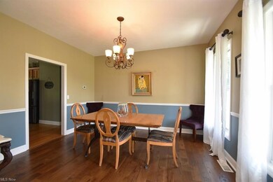 Dining room with chair rail and vinyl/wood floors.
