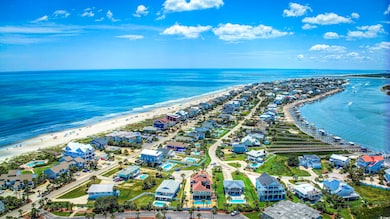 Aerial view of residential area featuring extended coastline
