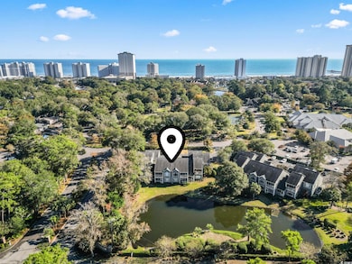Bird's eye view of a nearby body of water and a tree filled landscape