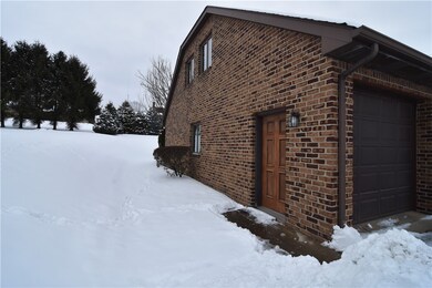 Left side entrance to garage, sidewalk from drive. Double entrance into home from interior of garage to LR and stairs to lower level.