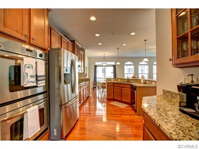 Large open kitchen with hardwood floors, stainless