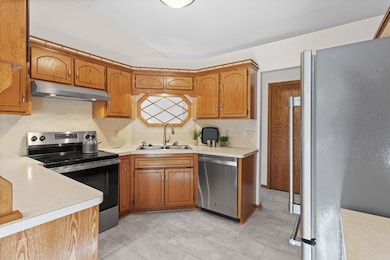 Main level: kitchen with new stainless appliances and LVT flooring