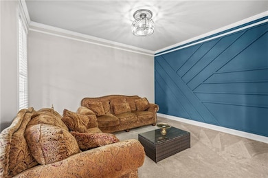 Carpeted living room with baseboards and ornamenta