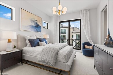 Bedroom featuring light carpet and an inviting cha