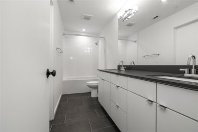Full bath featuring double vanity, shower / batht