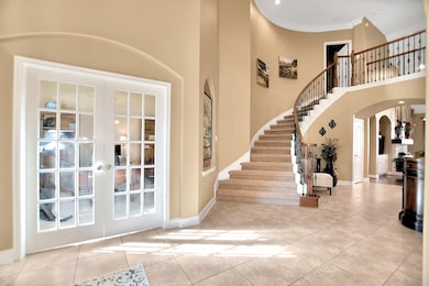 View of office and grand staircase from right of front door