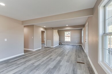 Living room opens to hallway to kitchen and master bedroom.
