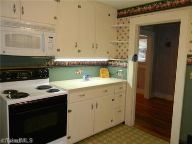 Kitchen. The cozy kitchen come with a stove and refrigerator.