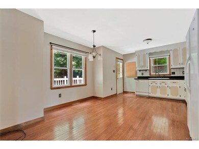 Spacious kitchen with wood floors, tile back splas