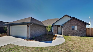 Ranch-style house featuring a garage, brick siding, driveway, and board and batten siding