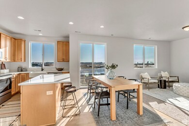 PHOTOS OF A SIMILAR HOME. COLORS, OPTIONS, AND FEATURES WILL VARY. Kitchen featuring recessed lighting, a center island, stainless steel electric range, plenty of natural light, and a breakfast bar