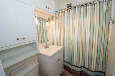Bathroom has newer flooring, vanity, lighting and 