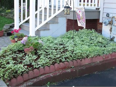 Exterior Front Many perennials planted around the 