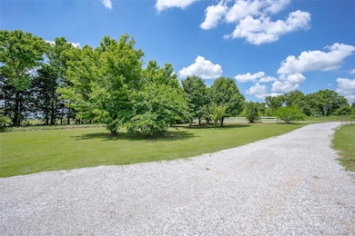 View of dirt / gravel road with a view of rural / pastoral area