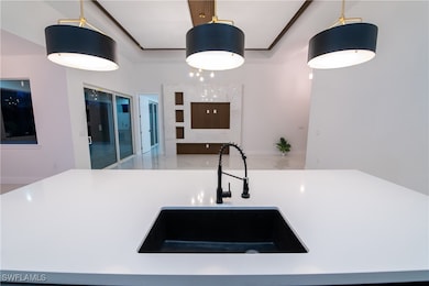 Kitchen with sink and decorative light fixtures