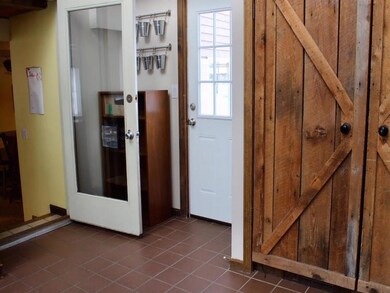 Mudroom with access to backyard and...