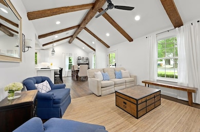 Living room with wood finished floors, a ceiling 