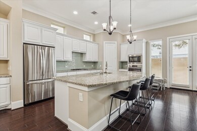 Modern kitchen with a large granite island. Featur
