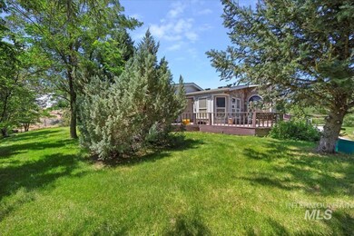 View of green lawn with a wooden deck