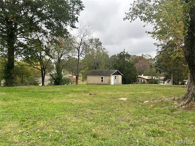 View of grassy yard with an outdoor structure