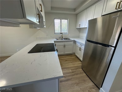 Kitchen with freestanding refrigerator, light wood