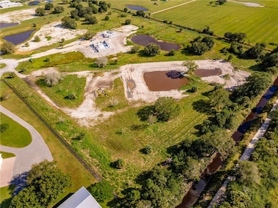 Aerial view of property and surrounding area featuring a large body of water