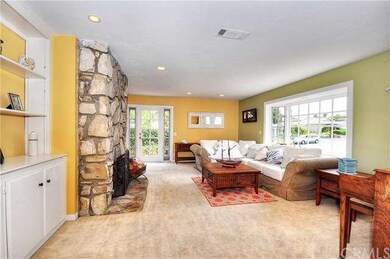 A large bay window overlooks the front yard, while
