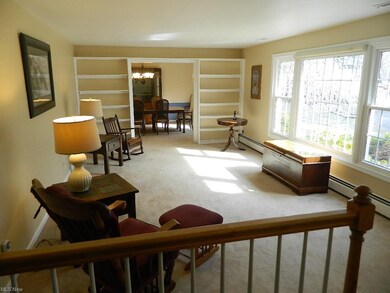 Step Down to the Formal Living Room Featuring Built in Bookcases and a Large Picture Window Overlooking the Landscaped Circular Driveway!