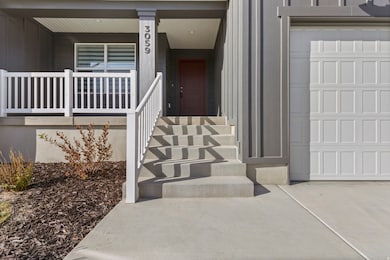 Entrance to property featuring a porch and a garage