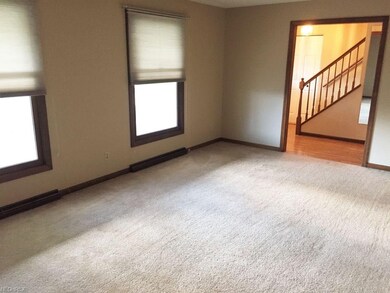 Large living room with newer carpeting.