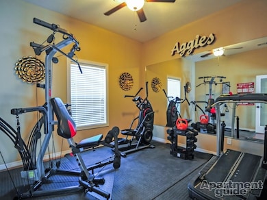 Workout area featuring ceiling fan and baseboards