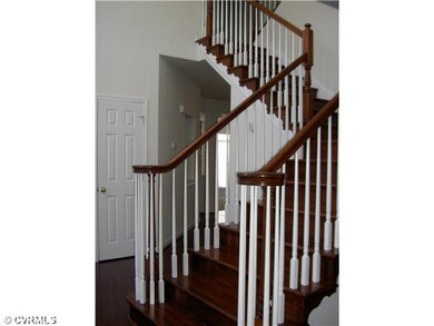 Foyer - Elegant two story foyer has a split stairc