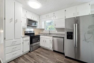 Kitchen with stainless steel appliances, a sink, d