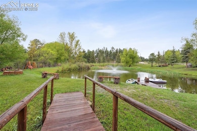 Dock featuring a water view and a lawn